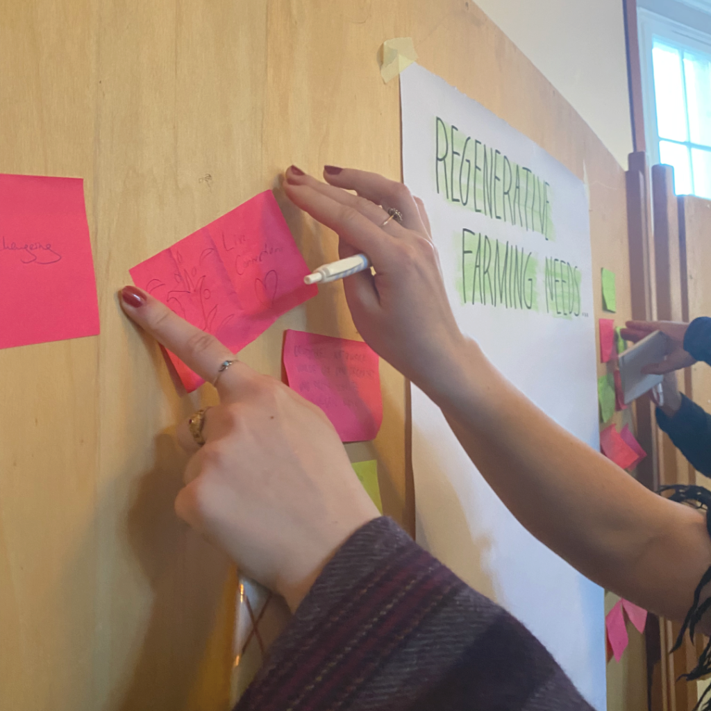 A woman putting a sticky note to a board